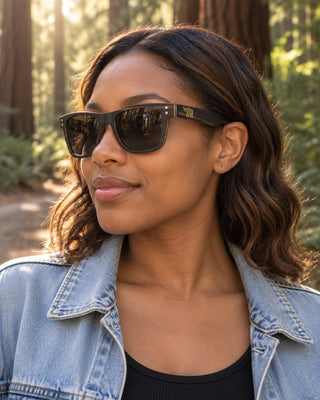 Big Basin polarized sunglasses worn by a woman on a sunlit redwood forest trail