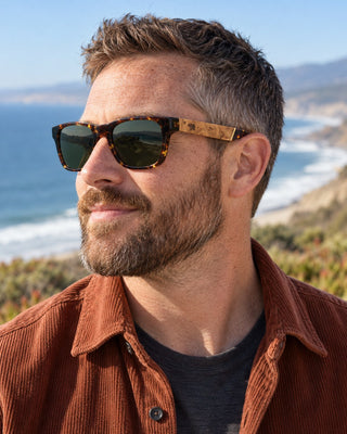 Buena Vista polarized sunglasses worn by a man on a coastal trail above the Pacific