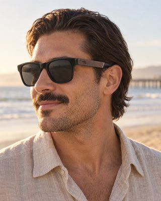Pismo Beach polarized sunglasses worn by a man on the beach near the Pismo Beach pier