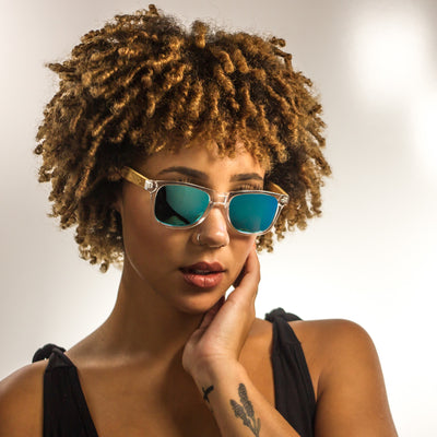 Malibu sunglasses worn on model, clear acetate with bamboo wood temples, polarized blue mirror lenses by Cali Life Co